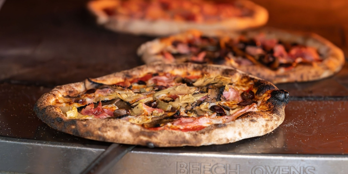 Tuck into the pizza at Treehouse Byron Bay