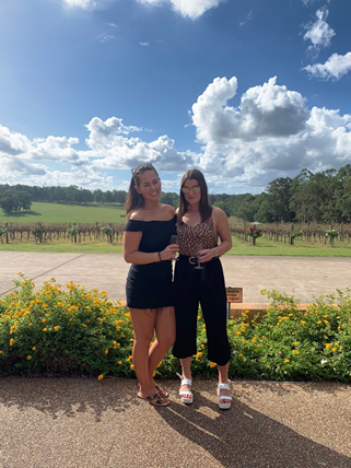 Two girls in front of winery